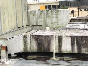 Rooftop ductwork and AHU note overall condition and probable mold